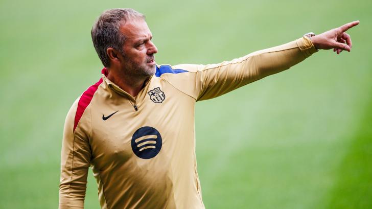 Barcelona boss Hansi Flick points while coaching his team